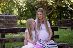 mother and daughter sitting on a bench during a maternity shoot at Lady Dixon Gardens Belfast, family portrait photographer