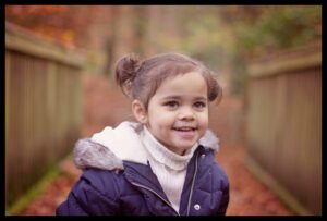 Outdoor family photo shoot in Belfast, beautiful little girl with the autumn leaves